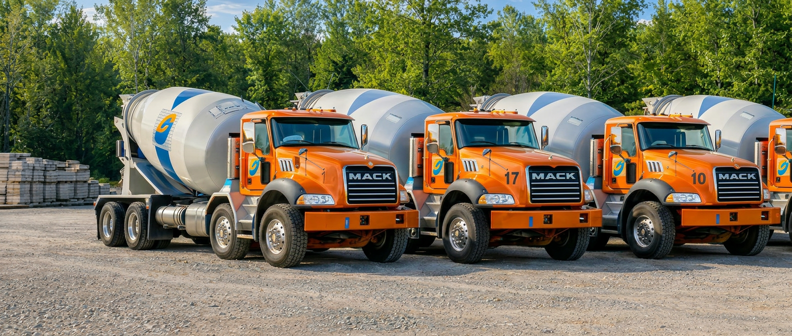 Casey Concrete fleet of orange Mack ready-mix trucks at the production yard